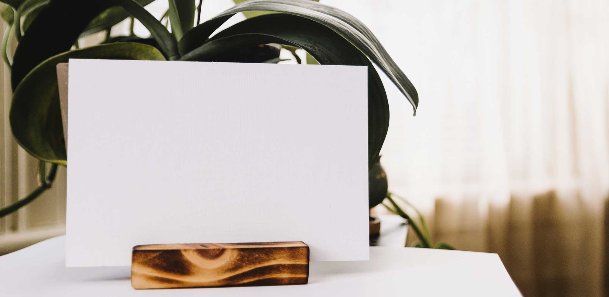 image of a white piece of paper in a wooden stand on a table