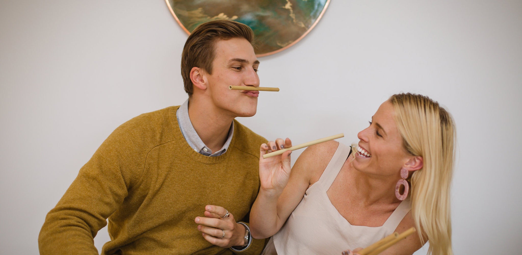 Lennart and Jamie, co founders of theotherstraw, smiling whilst holding bamboo straws